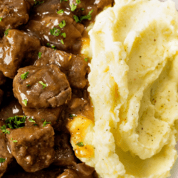 A labeled image of beef tips and gravy on a plate with mashed potatoes.